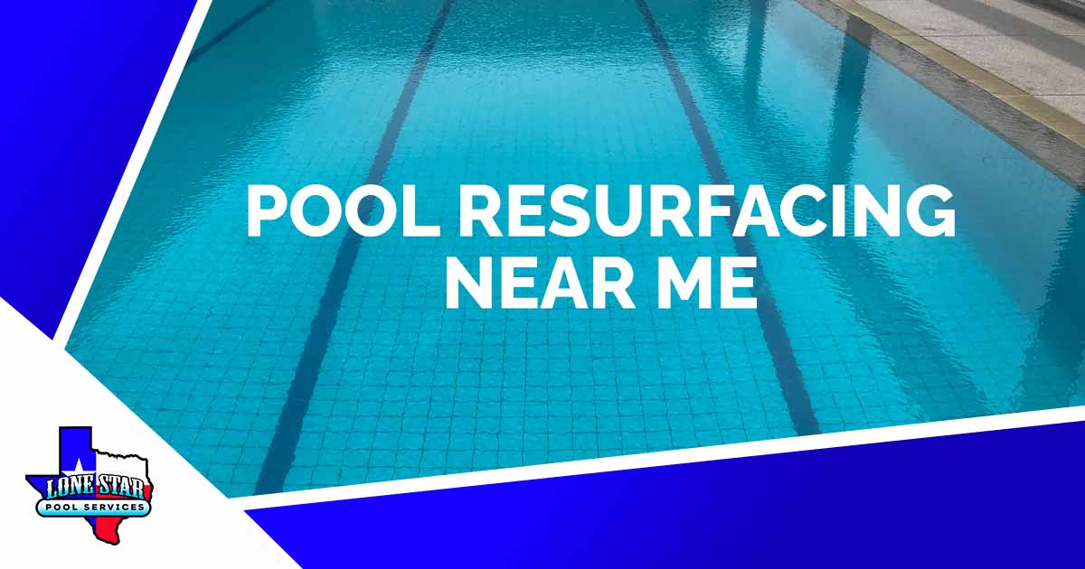 Image of an outdoor swimming pool with a starting platform at noon, featuring Lonestar Pool Services and highlighting pool resurfacing near me.
